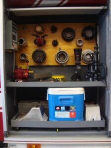 The engineer's compartment provides the driver of the truck with additional equipment that might be needed on the fireground, but is not readily accessible on the truck.  A toolbox is in the compartment to fix anything within reason and a cooler is provided for firefighters to have cold drinking water