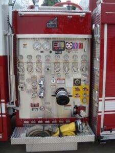300 has a Waterous single stage pump with a Williams WTP 1500 series foam tank.  A Detroit Diesel pressure governor is also installed on the pump panel.  A removable tri-pod light is to the left of the pump panel.  A booster line is above the pump panel.