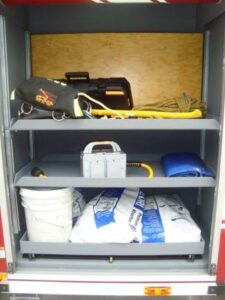 This compartment holds some of the excess equipment on the truck.  Oil-Dry for containing fluids at wrecks is in here.  Also, search rope and some hand tools are in here along with an electric saw-zall and an electric junction box.